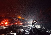 Stunning Photo of a Kiss Over Lava in the Rain 