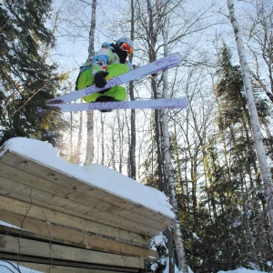 Skiing over wood pile