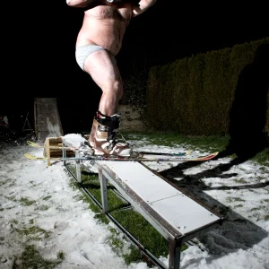 Ski + a lot of beers = Fat guy riding a rail naked!