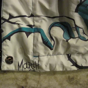 Jacket stain above "M"