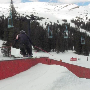 Erin (on Tele's) sliding the flat to down box in her heat of the rail jam