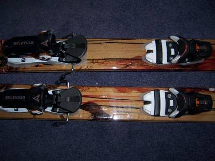 Binding. chip on right ski, approx. 1 inch long