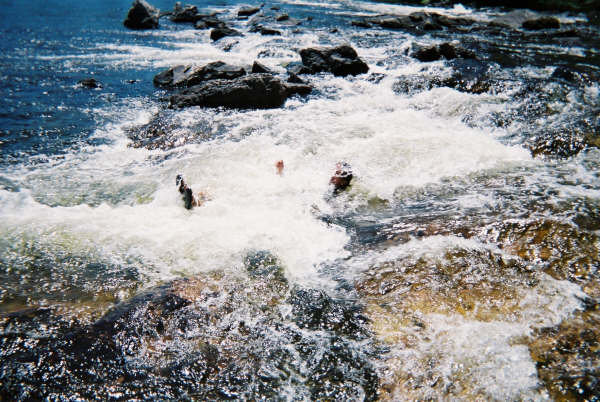 Bodysurfing rapids. Not so smart but fun.