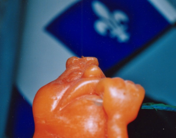 Candle dude thinking with quebec flag behind