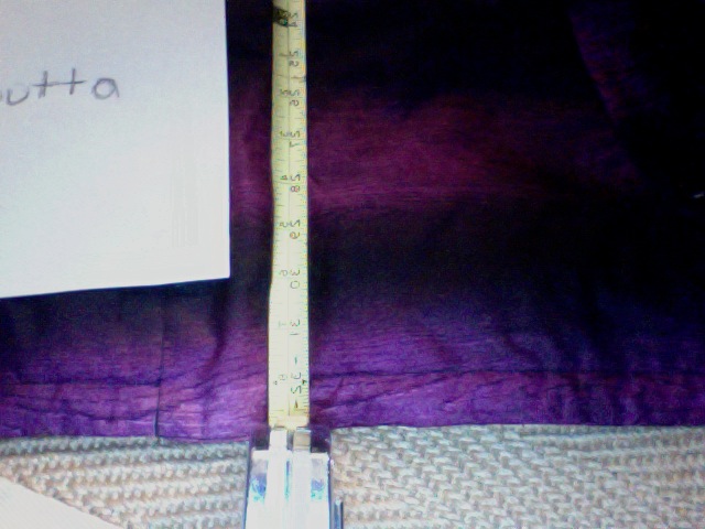 Close up shitty view of 33 mark on maeasuring tape  on jacket