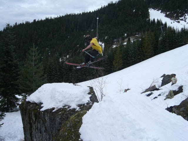 Half spin onto rock jib