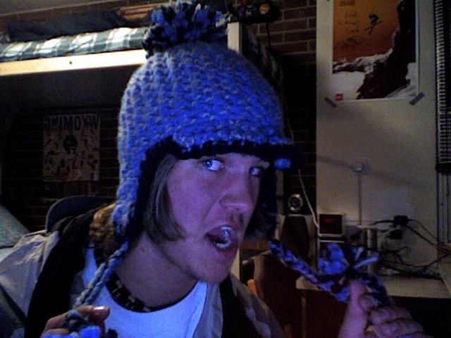 Hat with bill and earflaps