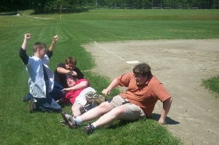 its 3 guys on their last day of school tackling the coolest teacher ever(in the one with his arms in
