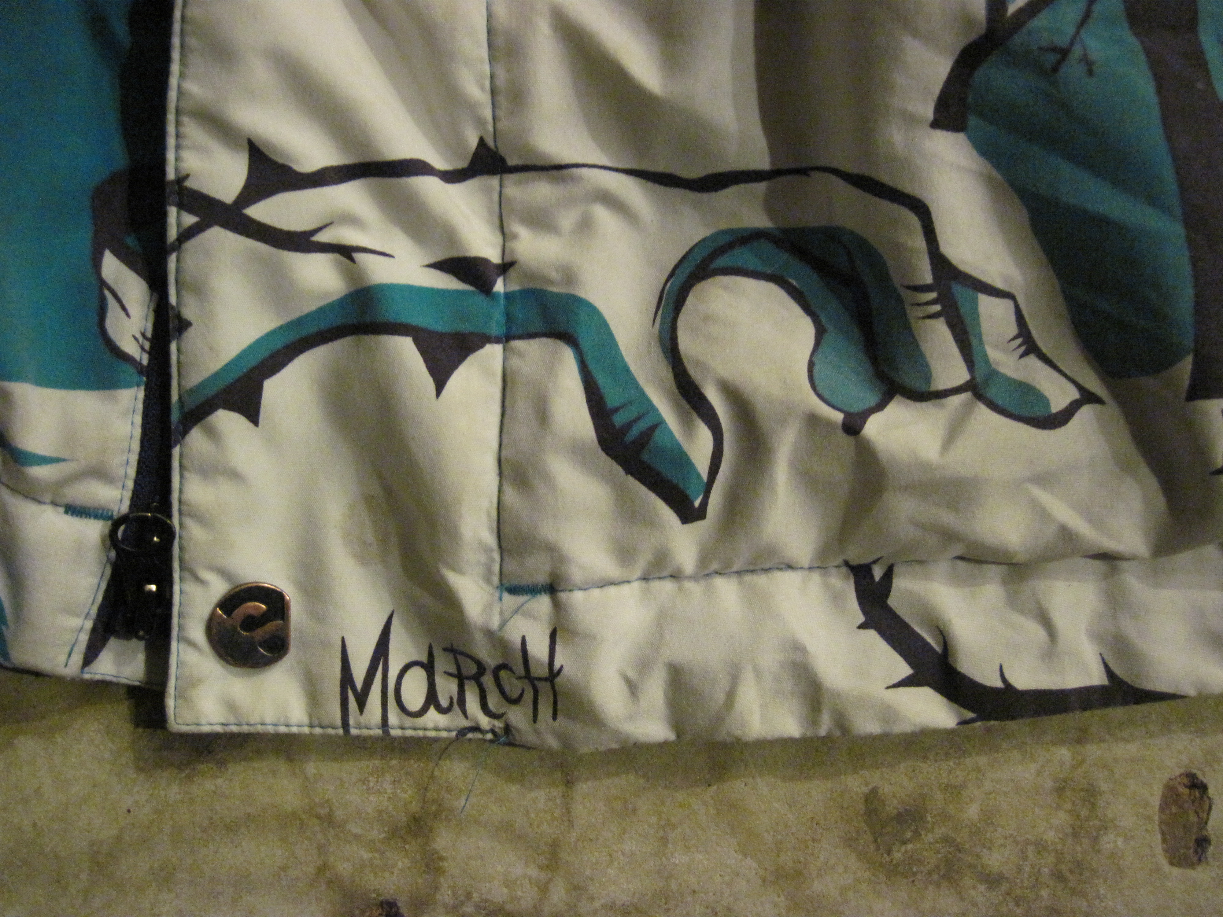 Jacket stain above "M"