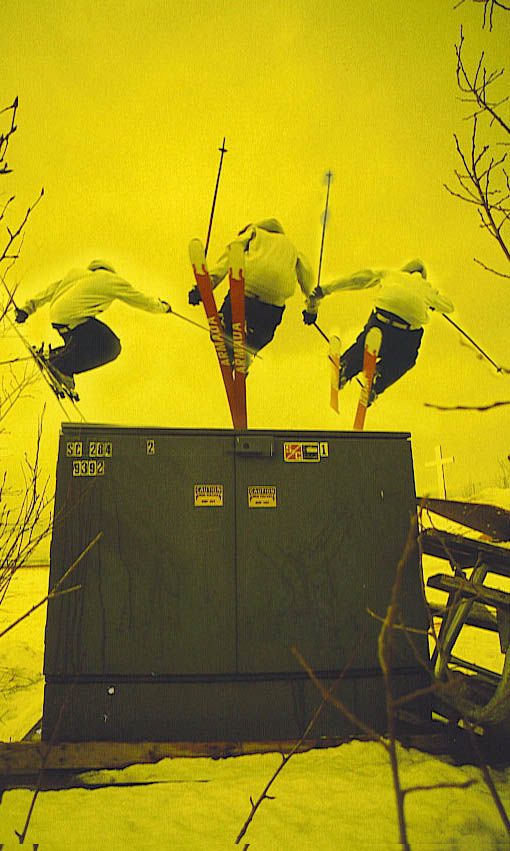 Josh skiing over a box