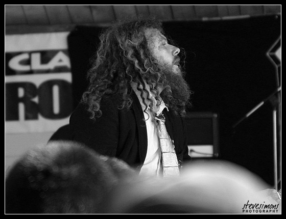 Long curly haired beared guitar playing fellow