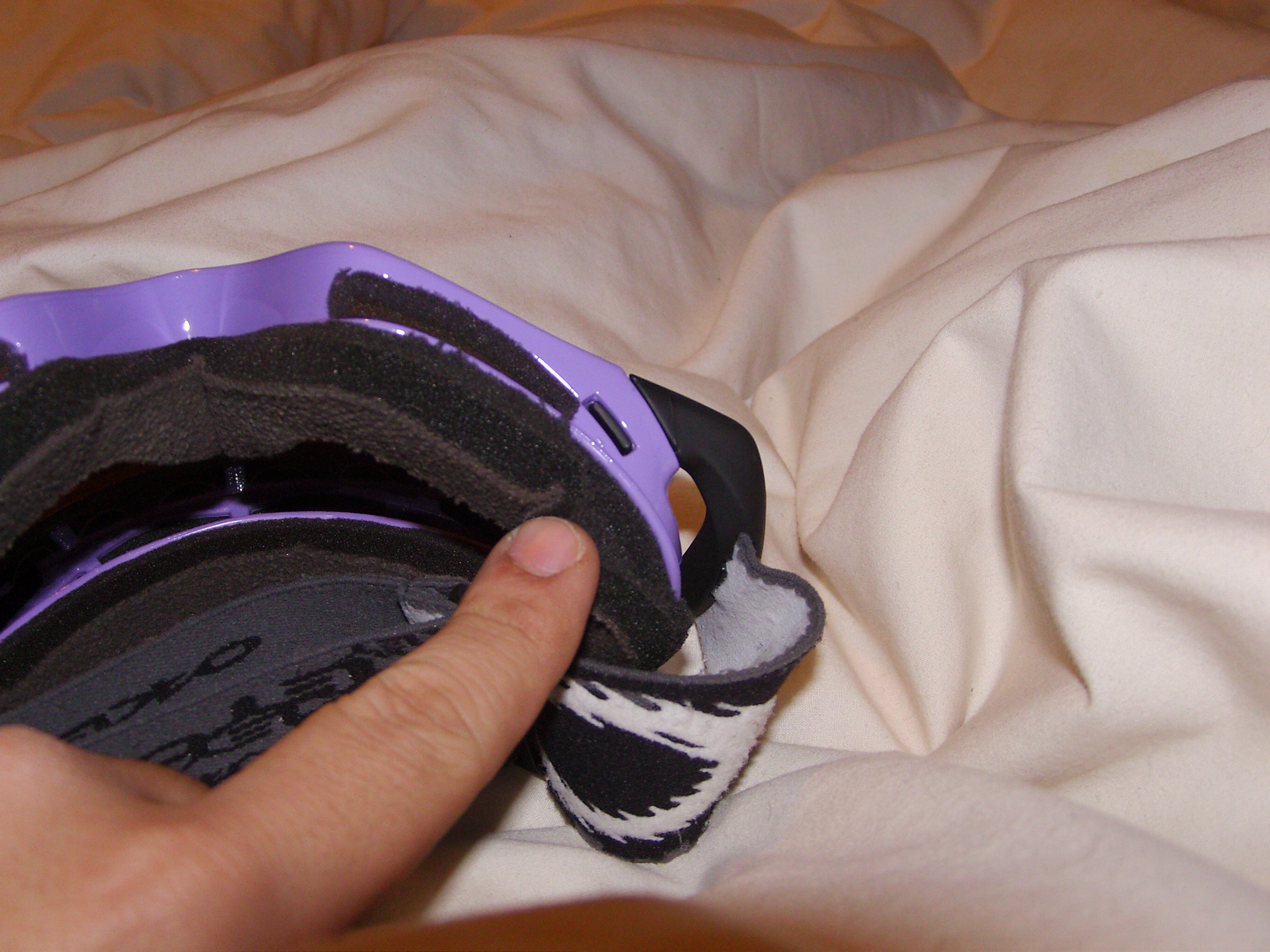 Minor foam tear, left side on face.