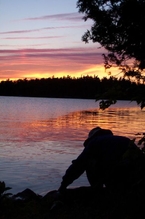 My dad was cleaning the fish at sunset. i thought it was a kick ass picture