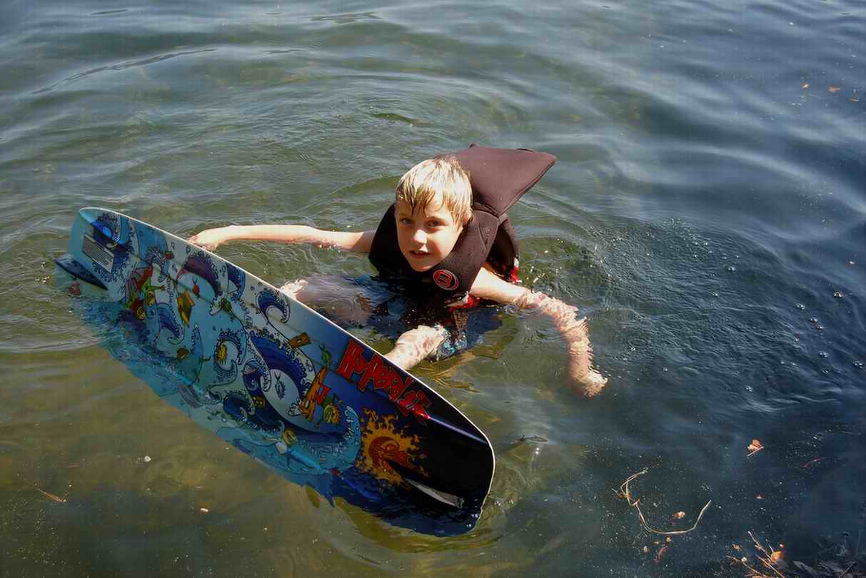 My little bro trying out his new wakeboard in the water