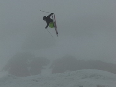 reverse tail grabing of the skis.