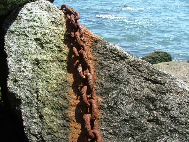 Rusty chain by the ocean