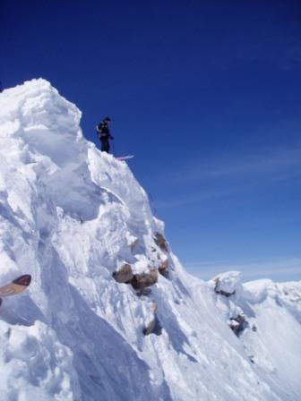 Scoping a drop off the peak at Crested Butte