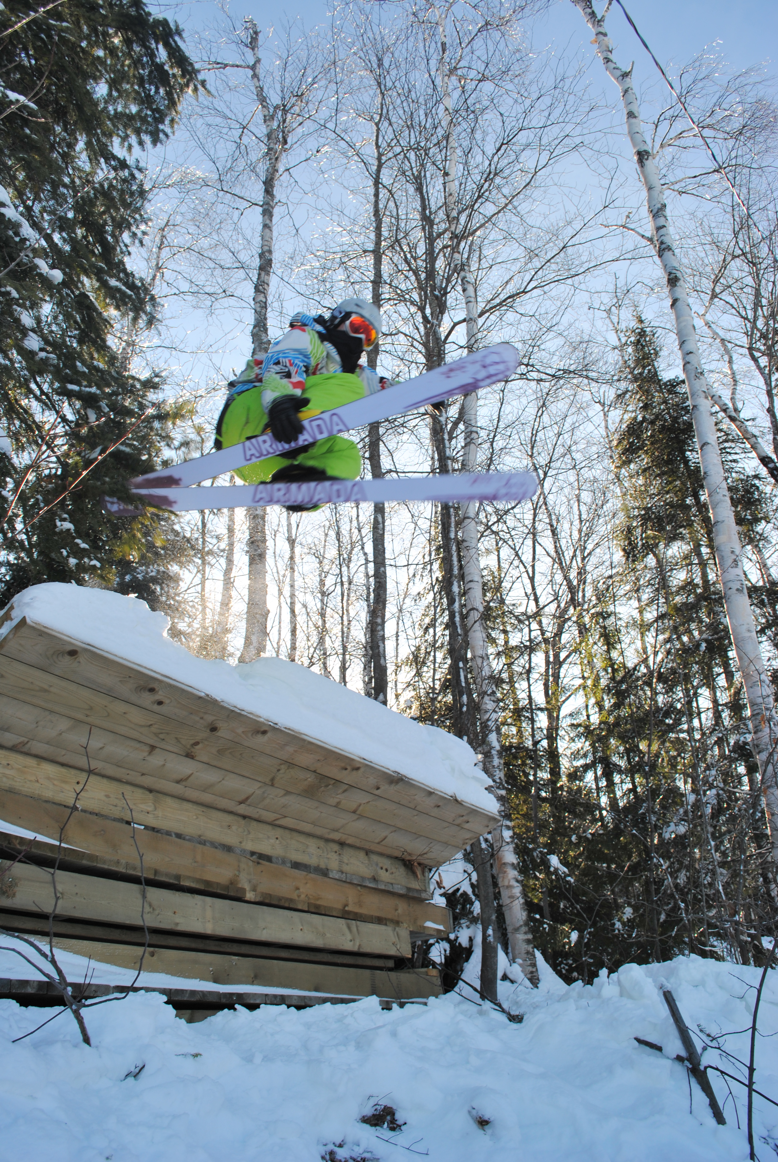 Skiing over wood pile