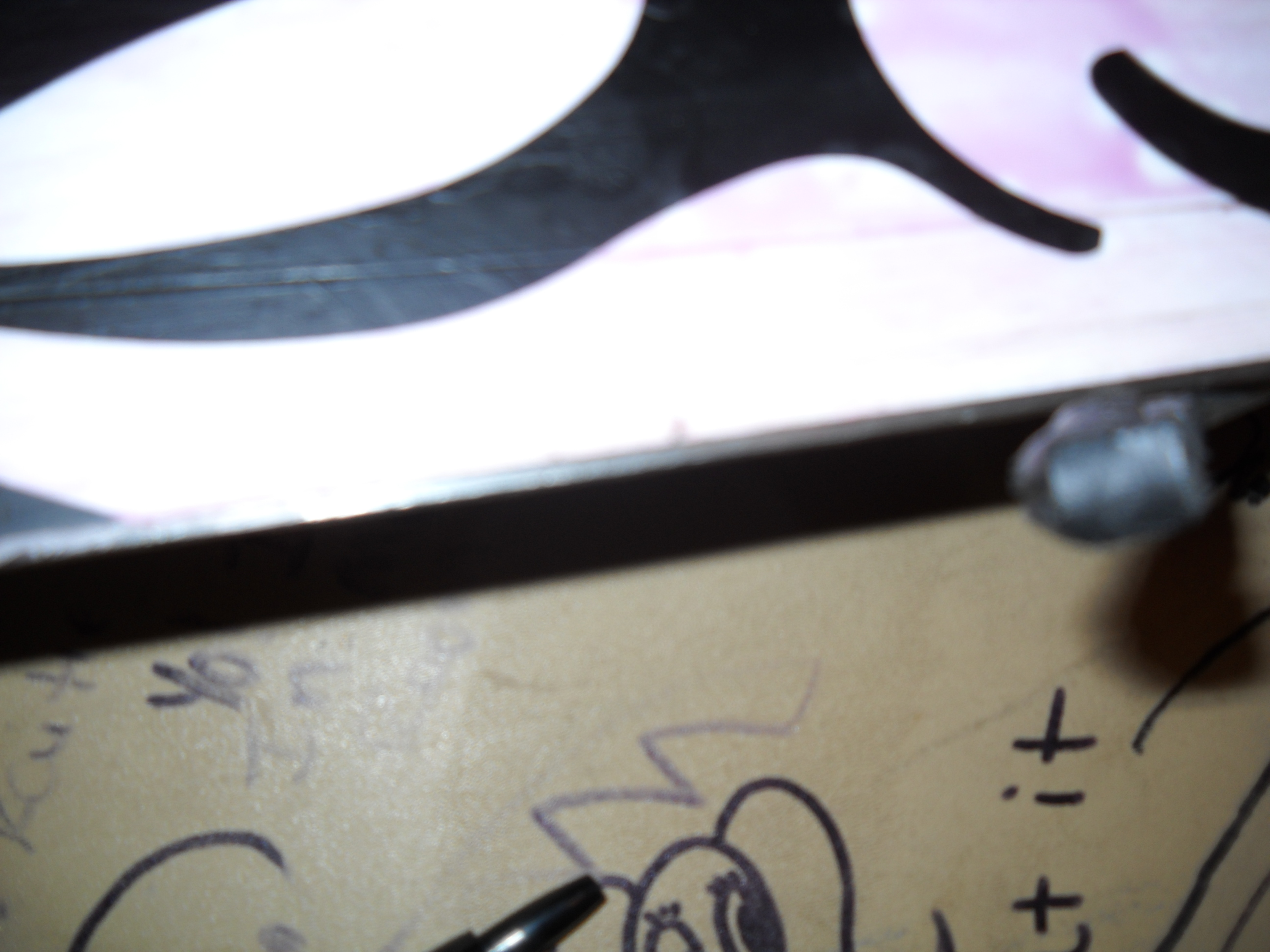 Small divot behind brake arm