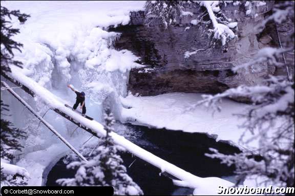 snowboarder log over lake