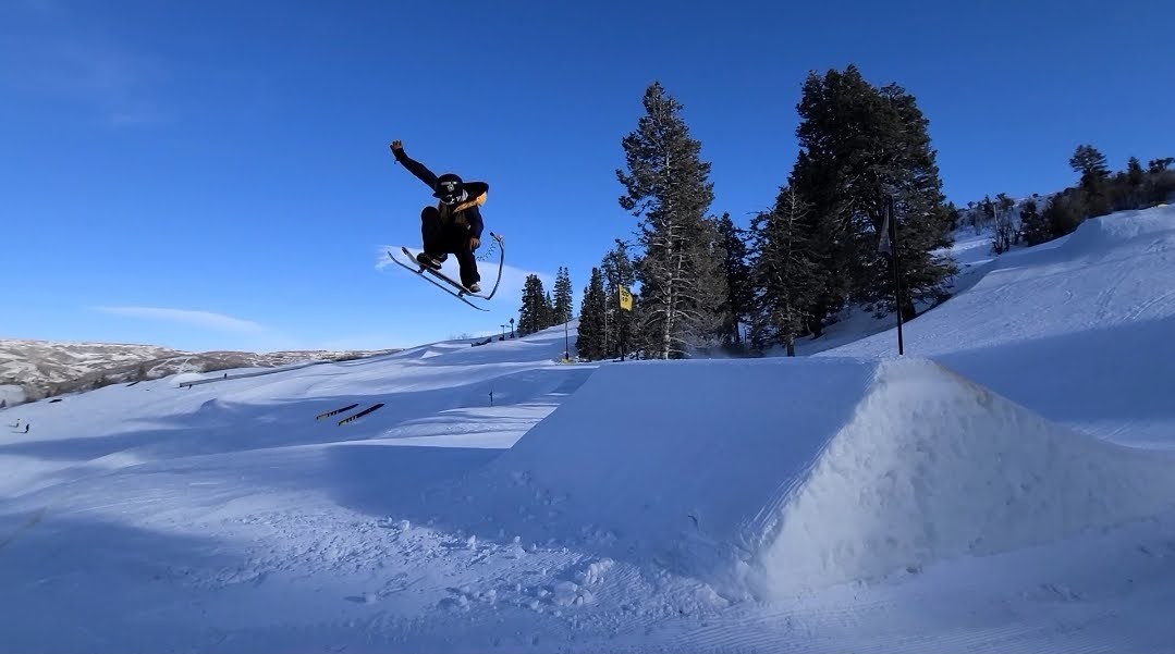 Snowskater Soaring Off the Booter